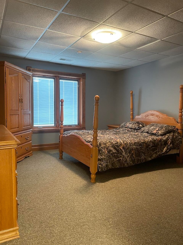 bedroom featuring carpet floors and a paneled ceiling