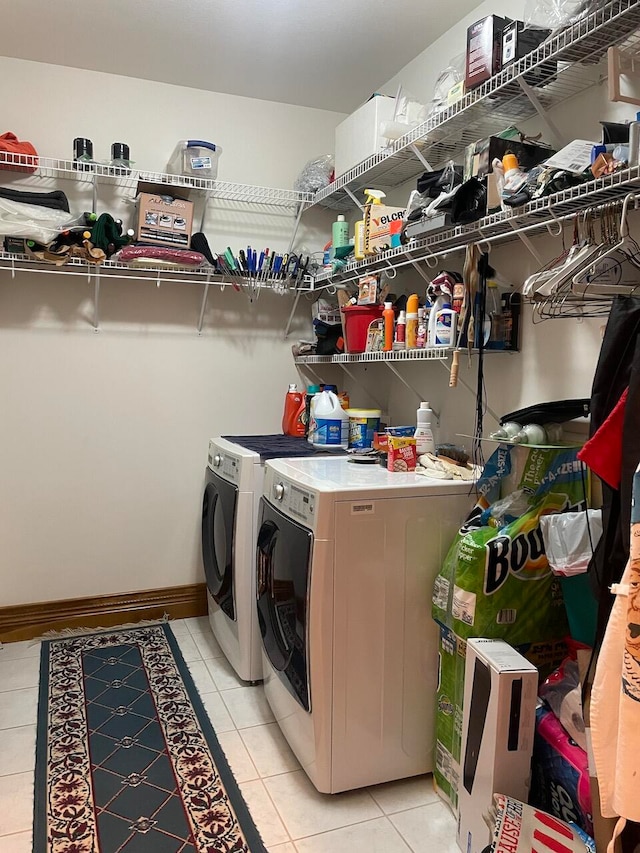 washroom featuring independent washer and dryer and light tile patterned floors