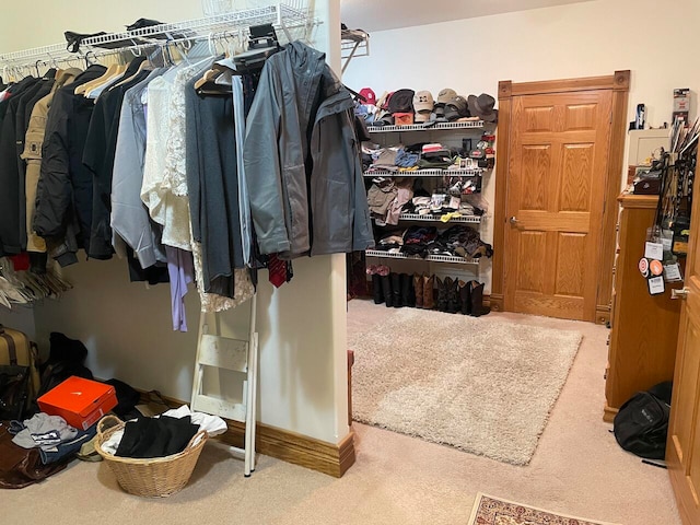 walk in closet with carpet