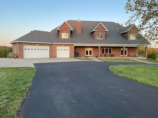 view of front of house featuring a garage and a yard