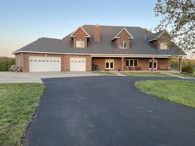 1179 County Road 1050, Willow Springs, MO 65793 - view of front of property featuring a chimney, a front lawn, aphalt driveway, a shingled roof, and a garage