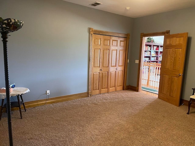 unfurnished bedroom with a closet and carpet