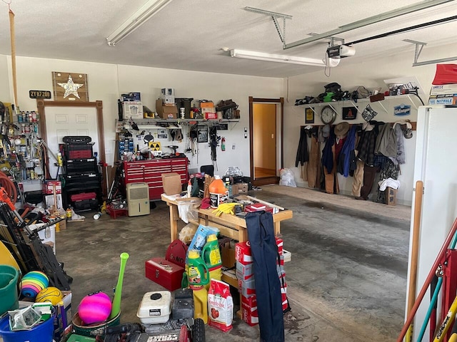 garage featuring a garage door opener and a workshop area