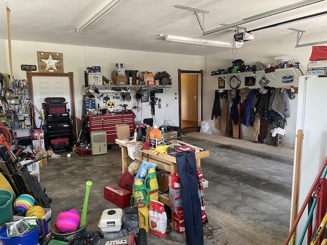 1179 County Road 1050, Willow Springs, MO 65793 - garage with a workshop area and a garage door opener