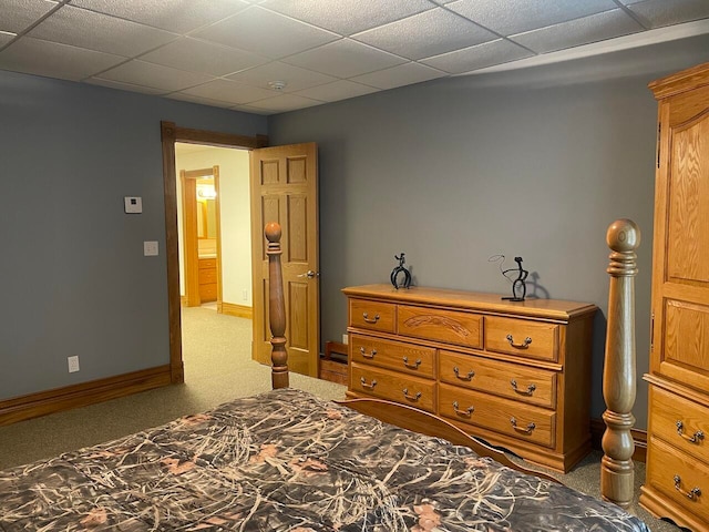 carpeted bedroom with a paneled ceiling