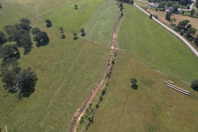 birds eye view of property with a rural view