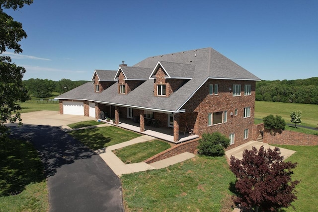 view of front of house featuring a garage and a front lawn