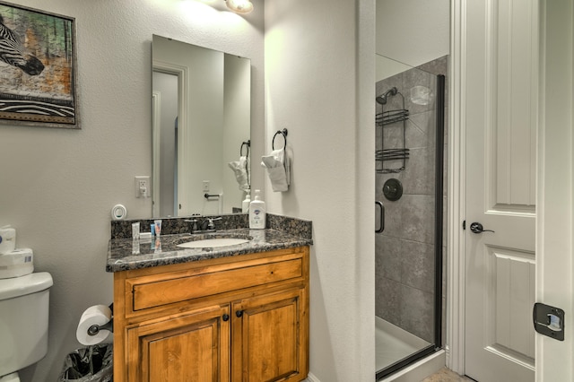 bathroom with vanity, toilet, and an enclosed shower