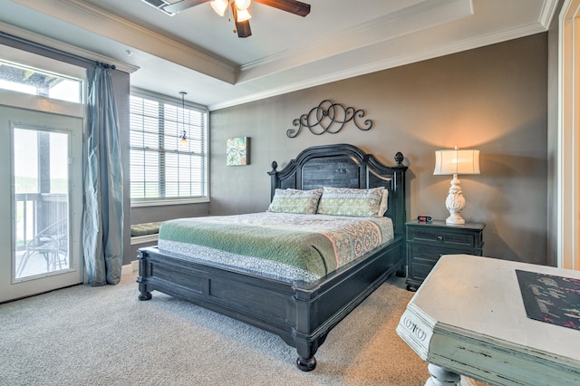 bedroom with ceiling fan, a raised ceiling, ornamental molding, light carpet, and access to exterior