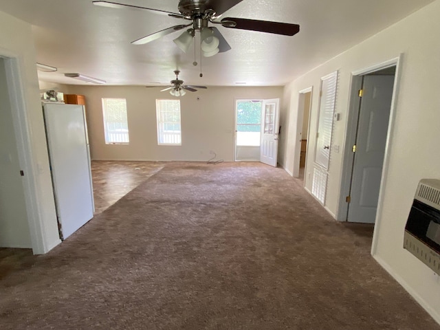 unfurnished living room featuring dark carpet and ceiling fan