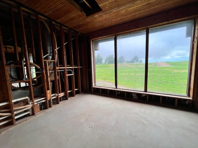 misc room with a rural view and concrete floors