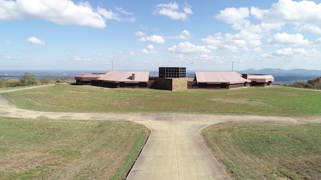 view of home's community featuring a lawn and a mountain view