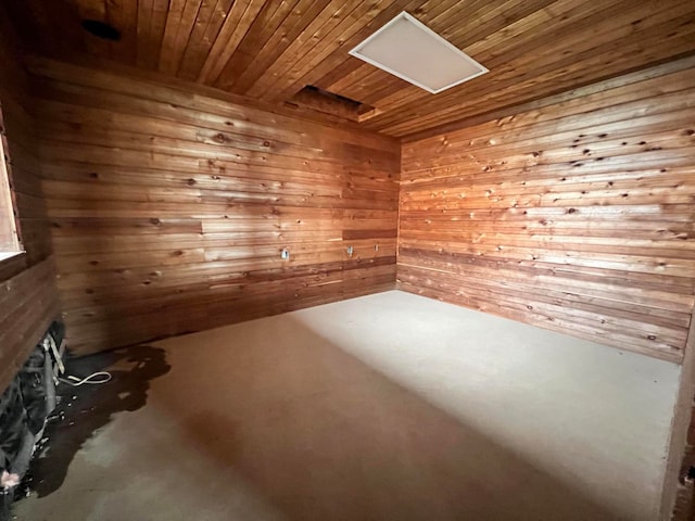 unfurnished room with wood walls and wood ceiling