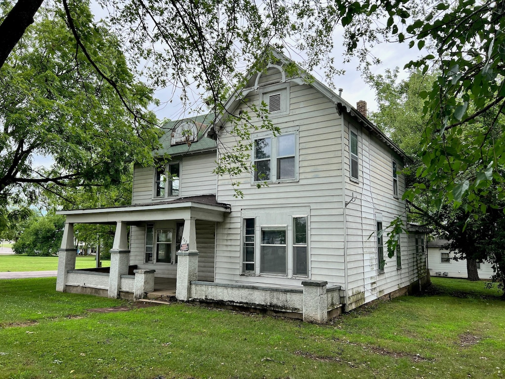 view of front facade with a front lawn and covered porch