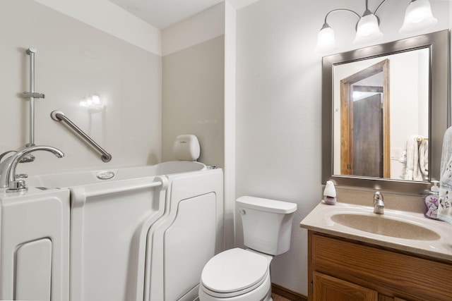 full bath featuring a tub to relax in, vanity, and toilet
