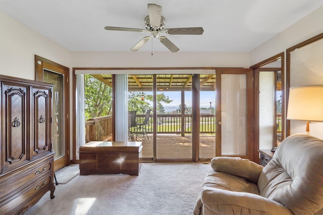 interior space featuring a ceiling fan and carpet