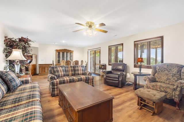 living area with light wood-style floors and ceiling fan