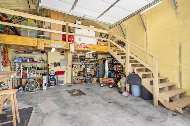 garage with electric panel and a workshop area