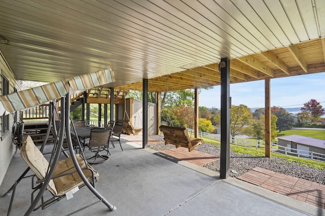 view of patio with stairway, fence, and outdoor dining area