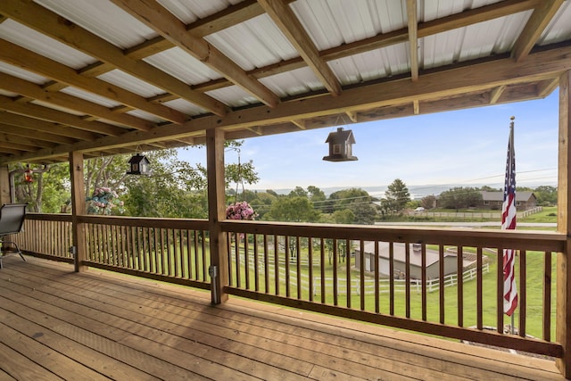 wooden terrace featuring a yard