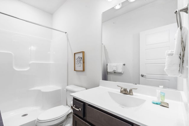 bathroom featuring walk in shower, vanity, and toilet