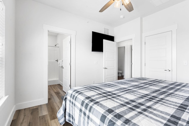 bedroom featuring wood-type flooring, a closet, connected bathroom, and ceiling fan