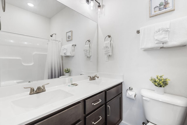 bathroom with vanity, walk in shower, and toilet