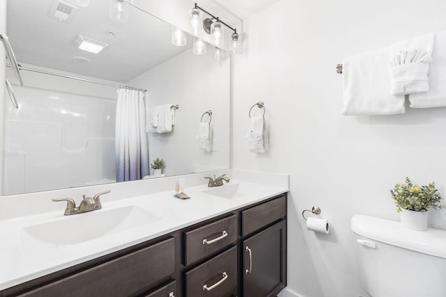 bathroom with vanity, toilet, and a shower with shower curtain