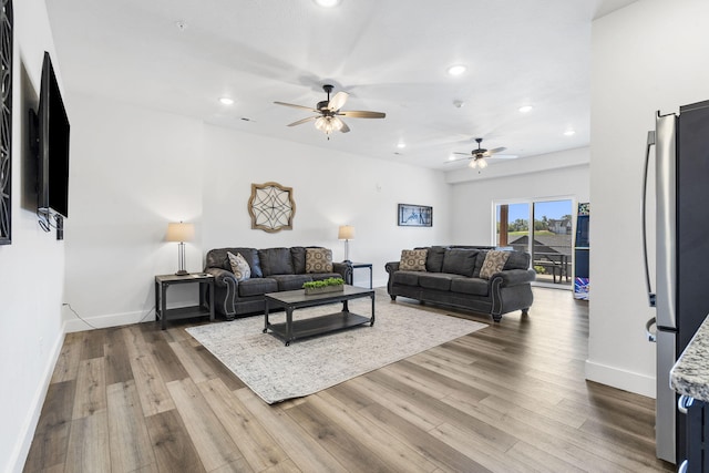 living room with ceiling fan and wood-type flooring