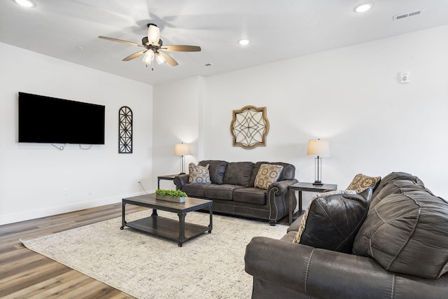 living room featuring hardwood / wood-style flooring and ceiling fan