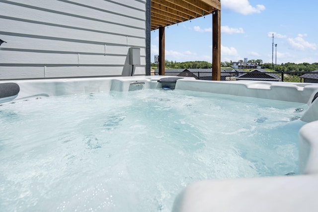 exterior details with concrete flooring and a hot tub