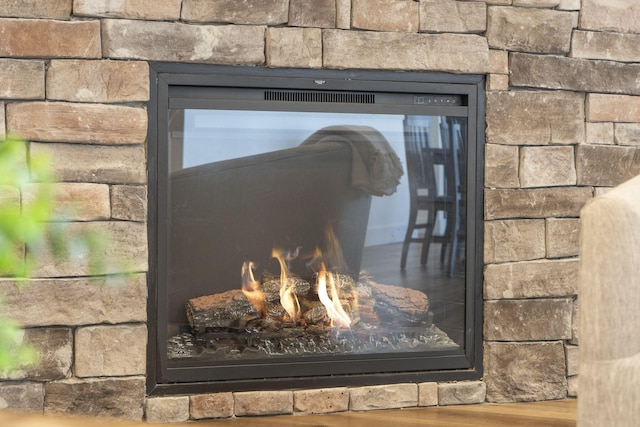 interior details with a stone fireplace