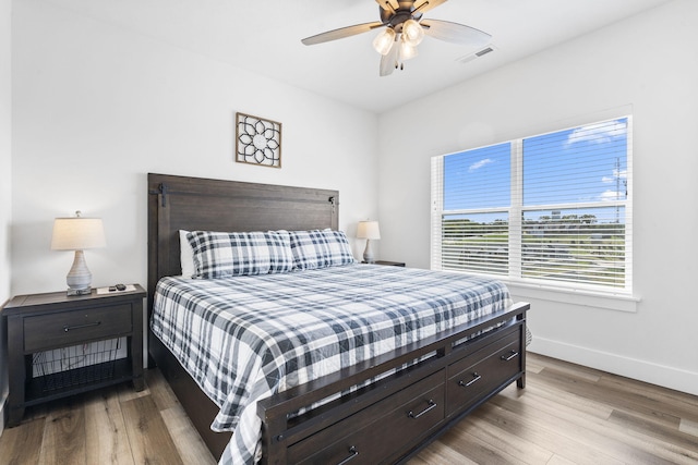 bedroom with light wood-type flooring and ceiling fan