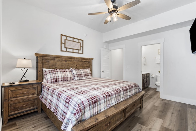 bedroom with hardwood / wood-style flooring, ceiling fan, and connected bathroom