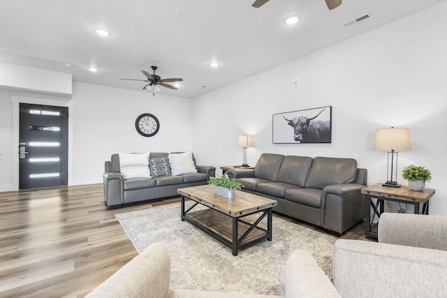 living room featuring ceiling fan and wood-type flooring