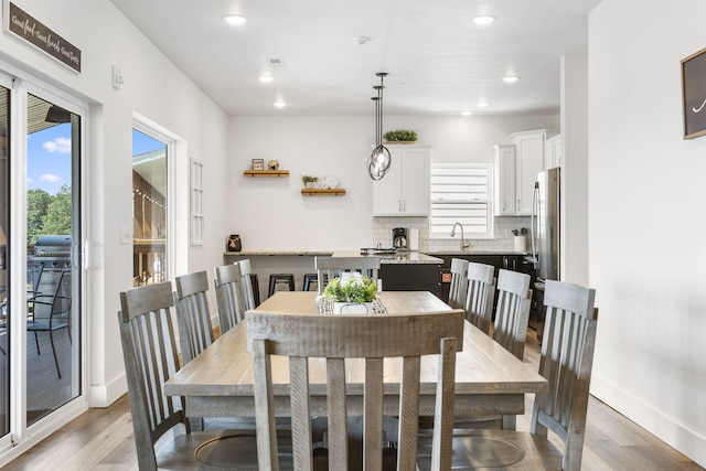 dining room with hardwood / wood-style flooring and sink