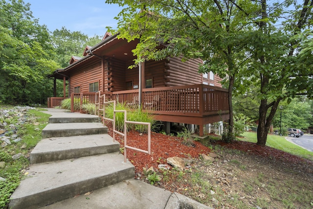 view of property exterior with a deck