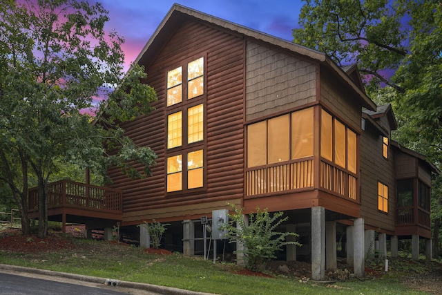 property exterior at dusk with a deck