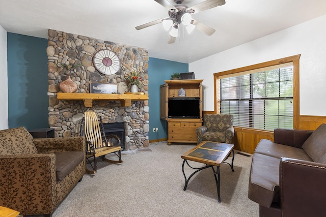 living room with ceiling fan, wooden walls, and light carpet