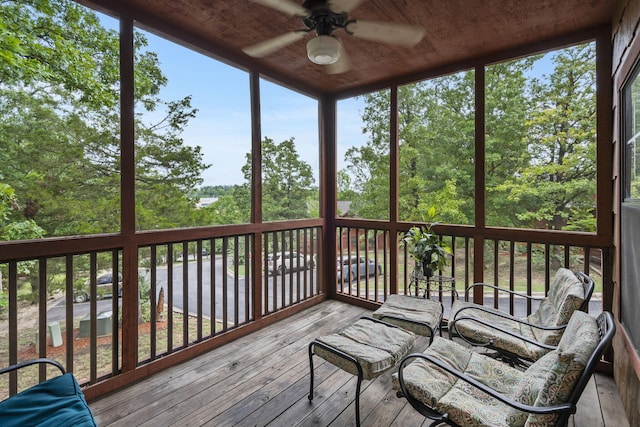 unfurnished sunroom with ceiling fan