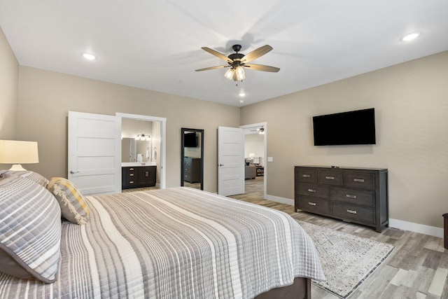 bedroom with recessed lighting, a ceiling fan, baseboards, light wood-style flooring, and ensuite bathroom