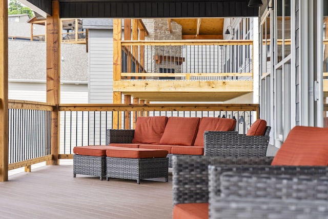 wooden terrace with an outdoor living space