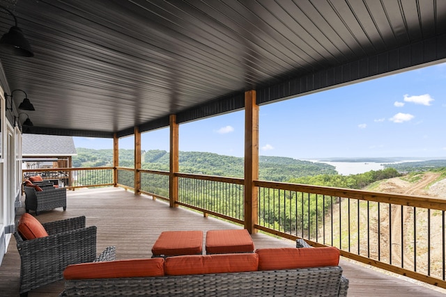 wooden terrace with an outdoor hangout area