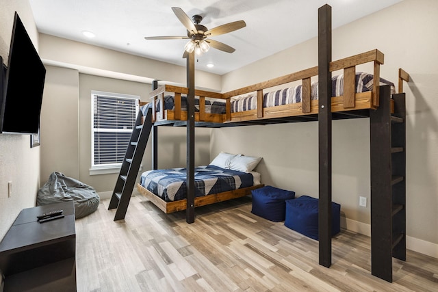 bedroom with light hardwood / wood-style flooring and ceiling fan