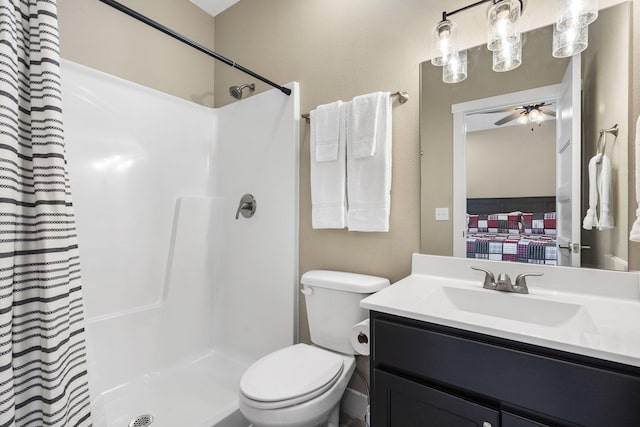 bathroom featuring ceiling fan, vanity, toilet, and curtained shower