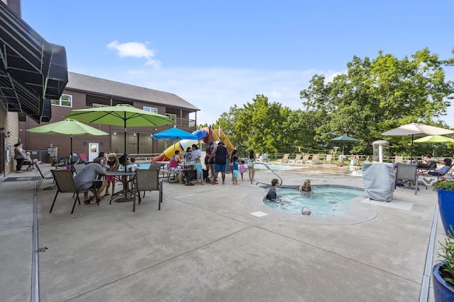 community pool featuring a patio and fence