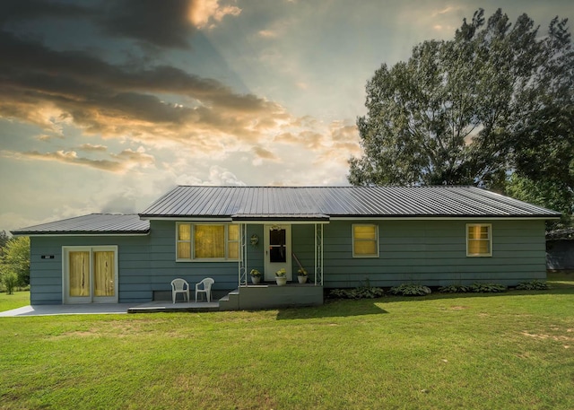 822 County Road 160, Fremont, MO 63941 - back of house at dusk featuring a lawn, a porch, and metal roof
