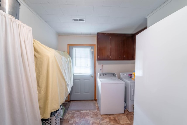 822 County Road 160, Fremont, MO 63941 - laundry room with washing machine and dryer, cabinet space, stone finish floor, and visible vents