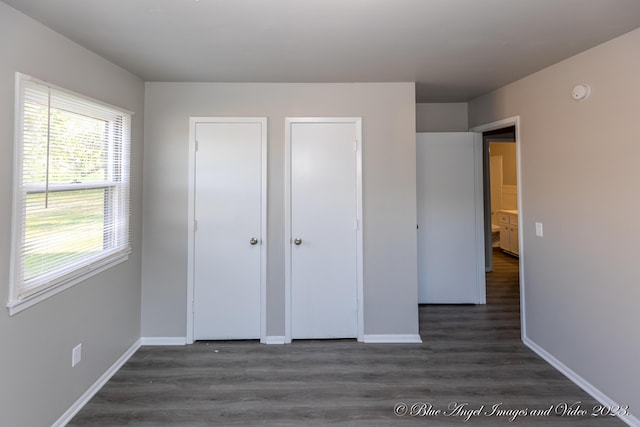 unfurnished bedroom with baseboards and wood finished floors