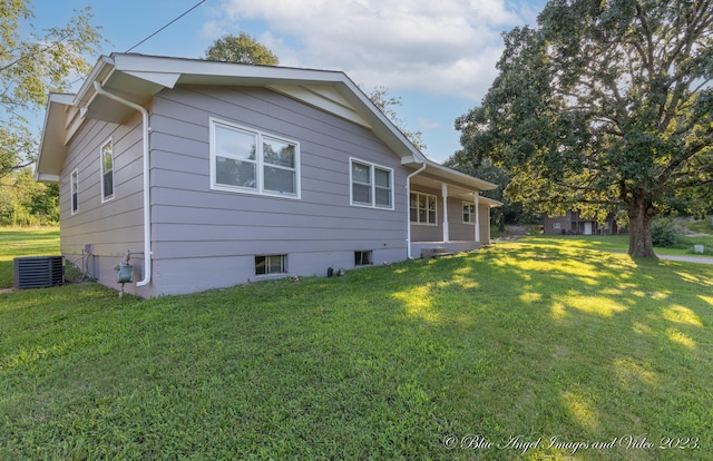 rear view of property with a lawn and central AC